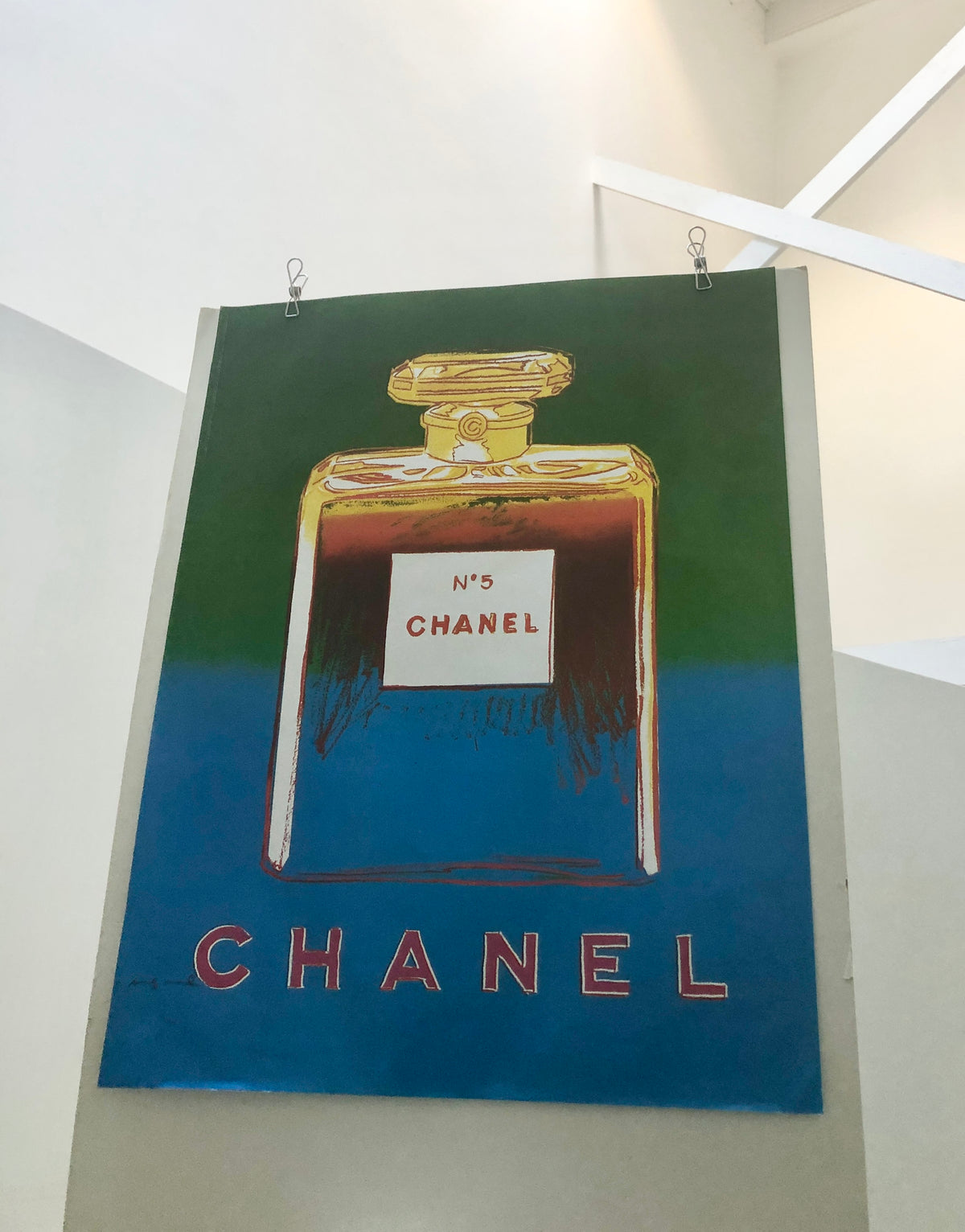 Photo of the full 1997 Andy Warhol blue Chanel poster showing the matte paper and print quality