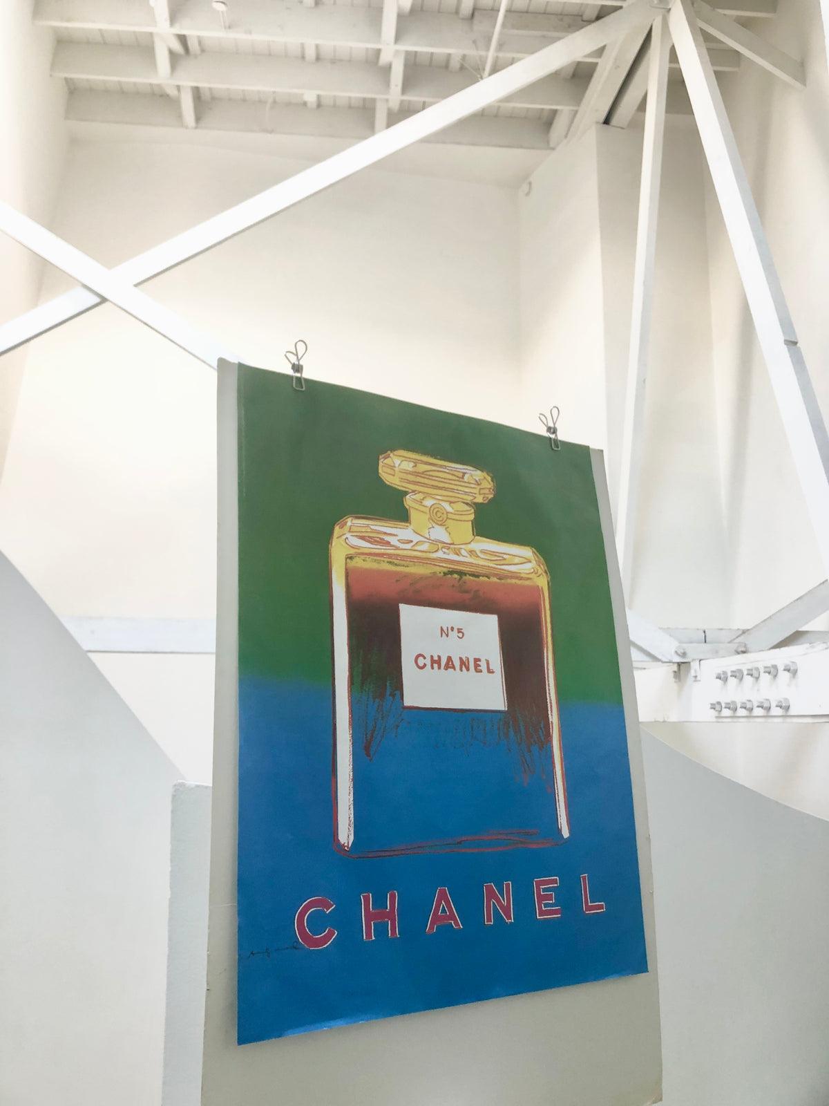 Angled side view of the 1997 Andy Warhol Italian Chanel blue poster